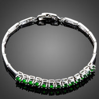 KHAISTA green CZ link chain bracelet on white background