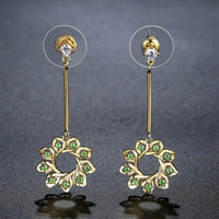 Close up of KHAISTA green CZ statement earrings