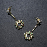 green CZ statement earrings detail view by KHAISTA