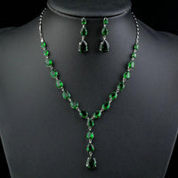 Side angle view of KHAISTA green CZ teardrop set