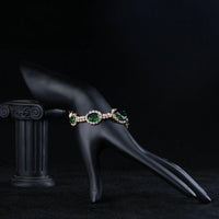 Side angle view of KHAISTA green geometric oval cut bracelet