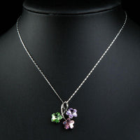 Close up detail of KHAISTA green pink purple flower pendant necklace
