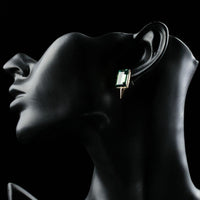 Side angle view of KHAISTA green rectangle crystal stud earrings