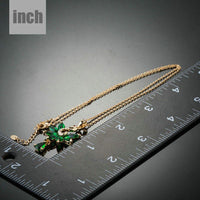 Pendant detail on KHAISTA green crystal swan pendant necklace