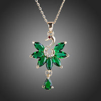 KHAISTA green crystal swan pendant necklace on white background