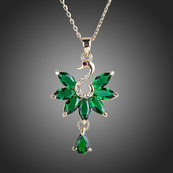 KHAISTA green crystal swan pendant necklace on white background