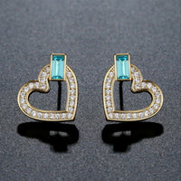 Close up of KHAISTA blue Austrian crystal heart stud earrings