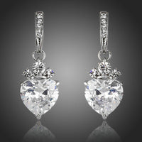 KHAISTA clear crystal heart drop earrings on white background