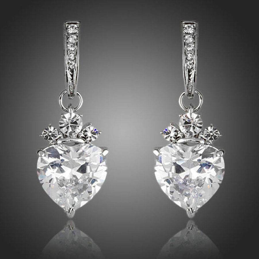 KHAISTA clear crystal heart drop earrings on white background
