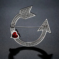 Side angle view of Khaista red heart arrow brooch