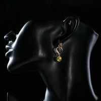 Close up of KHAISTA gradual change heart dangle drop earrings