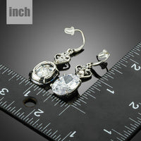 heart design oval crystal drop earrings detail view by KHAISTA