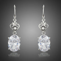 KHAISTA heart design oval crystal drop earrings on white background