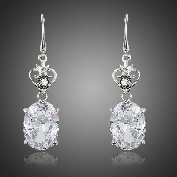 KHAISTA heart design oval crystal drop earrings on white background