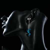 Close up of KHAISTA ocean blue crystal heart drop earrings