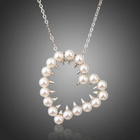 KHAISTA heart shaped pearl pendant necklace on white background