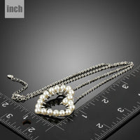 Pendant detail on KHAISTA heart shaped pearl pendant necklace