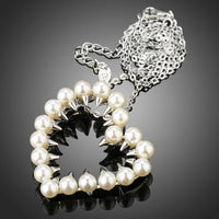 Close up detail of KHAISTA heart shaped pearl pendant necklace