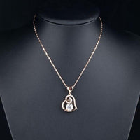 Side angle view of KHAISTA heart shaped snake chain crystal necklace