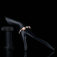 Side angle view of KHAISTA crystal heart stud bracelet
