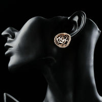 Close up of KHAISTA hollow flower crystal stud earrings
