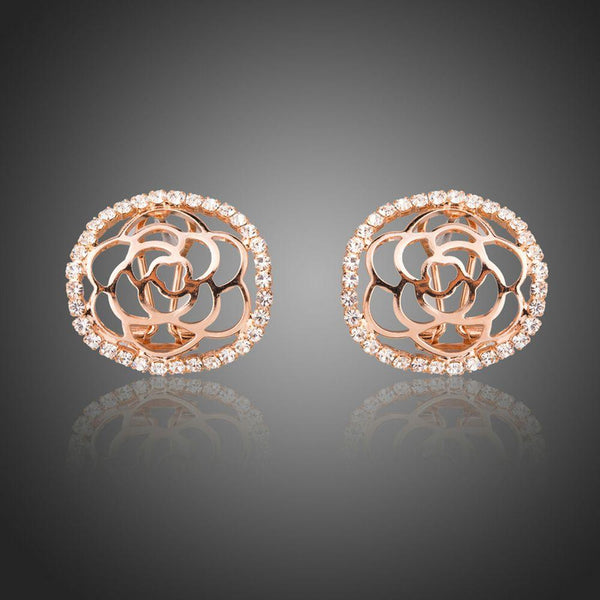 KHAISTA hollow flower crystal stud earrings on white background