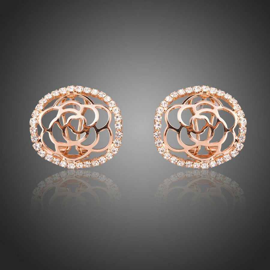 KHAISTA hollow flower crystal stud earrings on white background