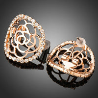 Side angle view of KHAISTA hollow flower crystal stud earrings