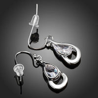 Close up of KHAISTA hook design CZ drop earrings