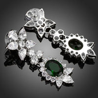 Close up of KHAISTA hooker's green CZ crystal drop earrings