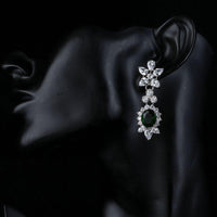 Side angle view of KHAISTA hooker's green CZ crystal drop earrings