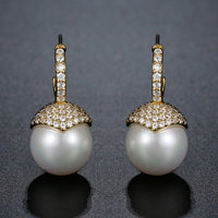 Close up of KHAISTA imitation pearl stud earrings