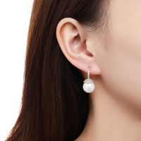 Side angle view of KHAISTA imitation pearl stud earrings