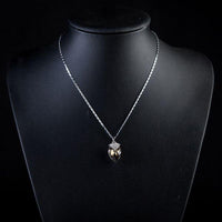 Close up detail of KHAISTA ink brown crystal pendant necklace