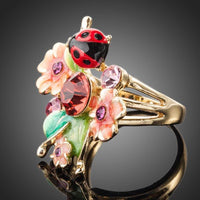 Detailed macro close up view of the brilliant stone settings on this premium floral insect crystal ring