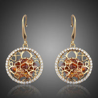 KHAISTA irregular gold CZ drop earrings on white background