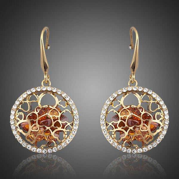 KHAISTA irregular gold CZ drop earrings on white background
