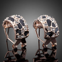 Close up of KHAISTA jaguar design crystal clip earrings