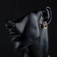 Side angle view of KHAISTA jaguar design crystal clip earrings