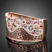 Close up detail of KHAISTA jaguar print crown bangle