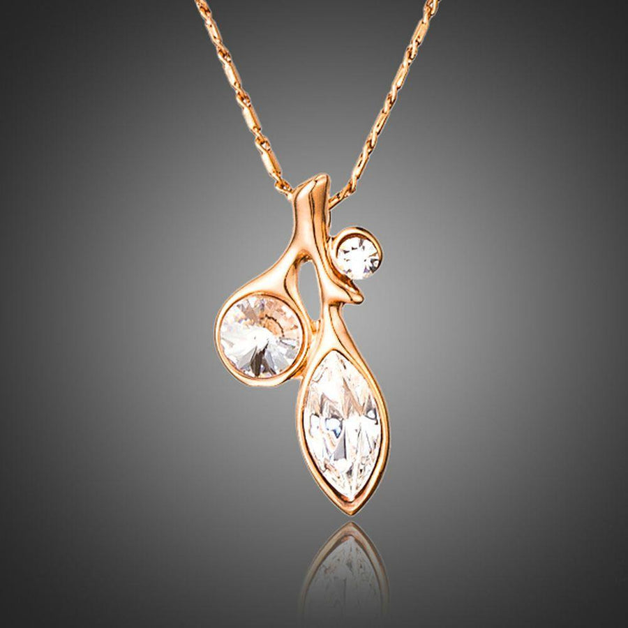 KHAISTA leaf shaped crystal pendant necklace on white background