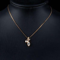 Side angle view of KHAISTA leaf shaped crystal pendant necklace