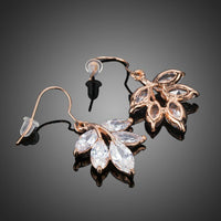 Close up of KHAISTA leaf shaped zircon drop earrings