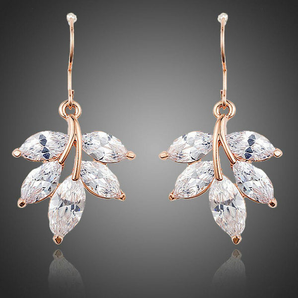 KHAISTA leaf shaped zircon drop earrings on white background