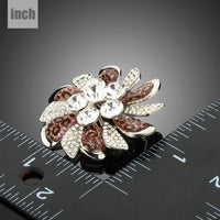 Windmill design detail on Khaista leopard print brooch
