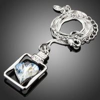 Close up detail of KHAISTA light blue crystal heart pendant necklace