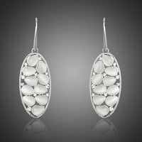 KHAISTA light grey crystal oval drop earrings on white background