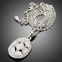Close up detail of KHAISTA light grey oval crystal necklace