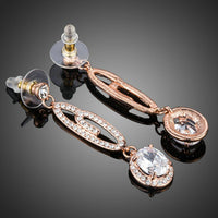 Close up of KHAISTA lightweight dangling G-shape drop earrings
