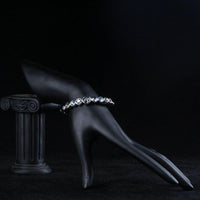 Side angle view of KHAISTA lightweight platinum crystal bangle